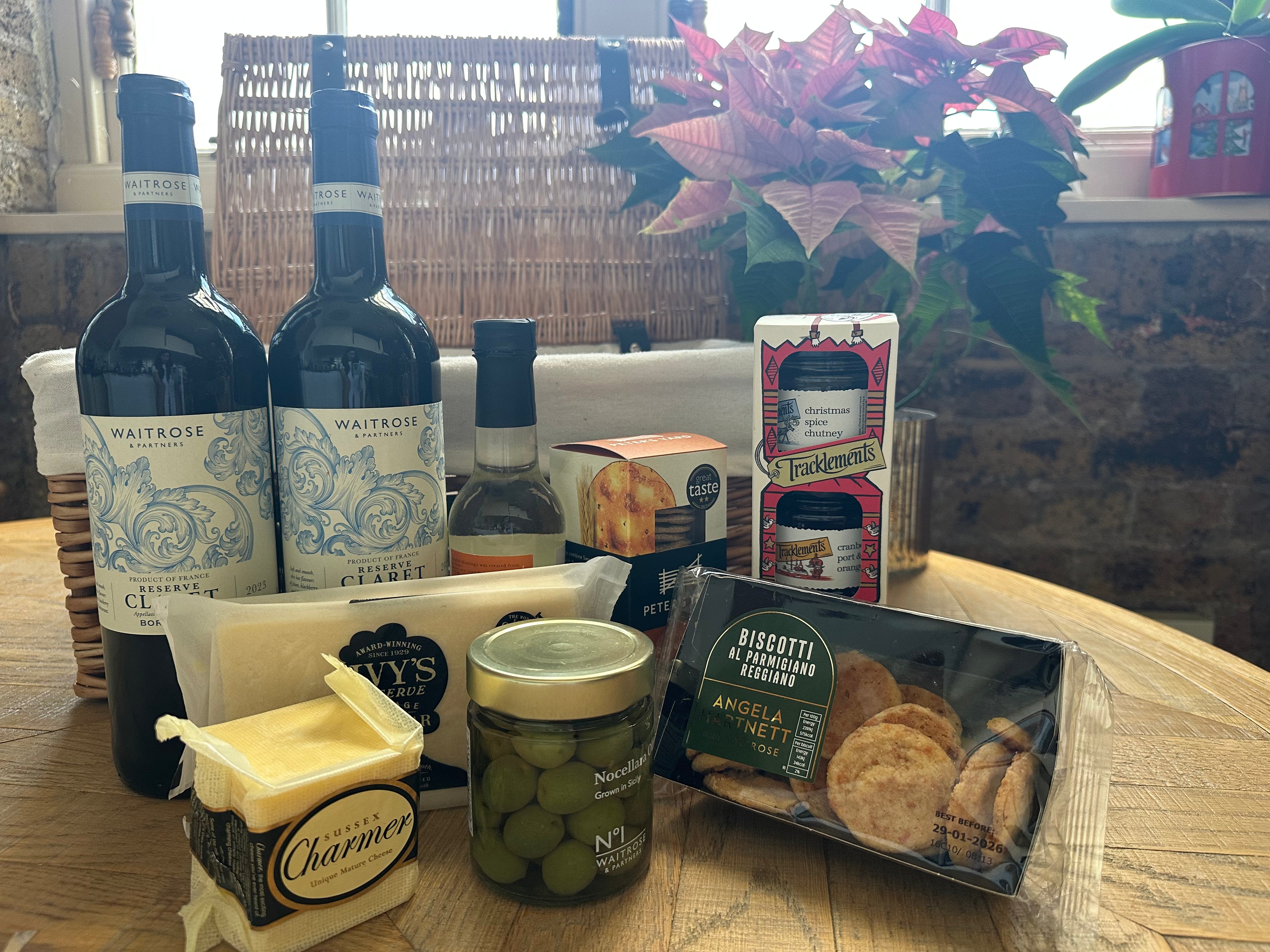 Assorted food items including wine, cheese, and crackers on a table.